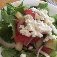Mediterranean Salad · Mixed greens, tomatoes, cucumbers, red cabbage, onion, carrots and olives. Topped with feta ...