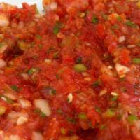 Acili Ezme · Spicy Vegetables. Mashed tomatoes, green and red peppers and onions mixed with walnuts, garl...