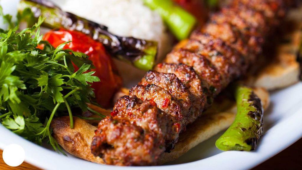 Lamb Adana Kebab · Slightly seasoned hand-chopped lamb flavored with red bell peppers and grilled on skewers. Served with rice and house salad