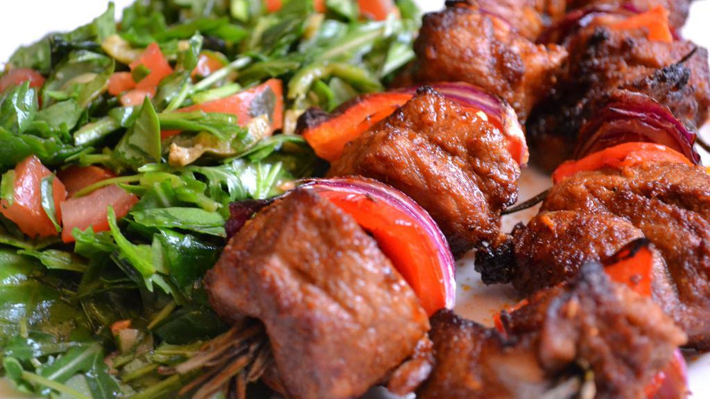 Lamb Shish Kebab · Cubes of baby lamb marinated in our special sauce and char-grilled to delight on skewers. Served with rice and house salad