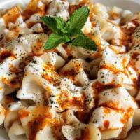 Manti · Homemade dumplings. Dough stuffed with ground meat, onions and spices. Served with garlic yo...