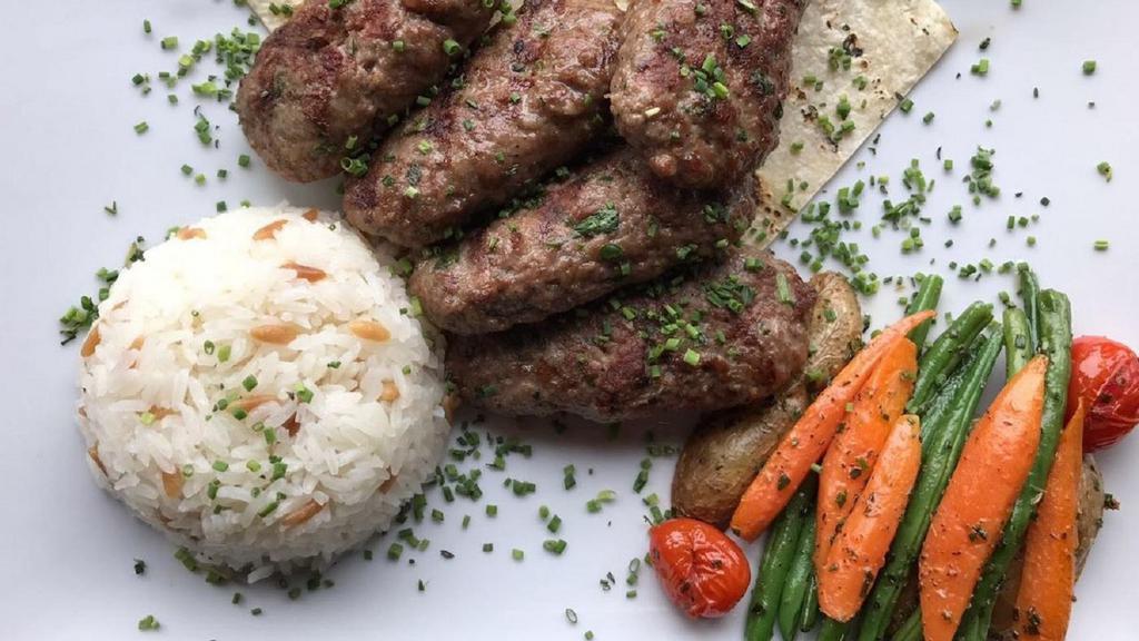 Turkish Meatballs (Kofte) · Ground meat mixed with onions and special spices. Served with rice and house salad