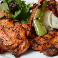 Chicken Chops · Char-grilled chicken leg and thigh. Served with rice and house salad