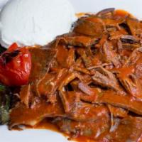 Iskender Kebab · Lamb gyro kebab in a lightly hot tomato sauce over toasted pita bread. Served with yogurt