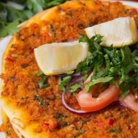 Lahmacun (2 Pieces) · Turkish thin dough meat pie topped with a blend of ground lamb and spices. Served with parsl...
