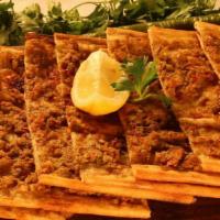 Kiymali Pie · Thin crust topped with a blend of ground lamb, onions and black pepper