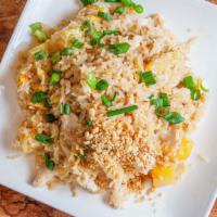 Pineapple Coconut Fried Rice · Coconut fried rice with chicken topped with ground peanuts.
