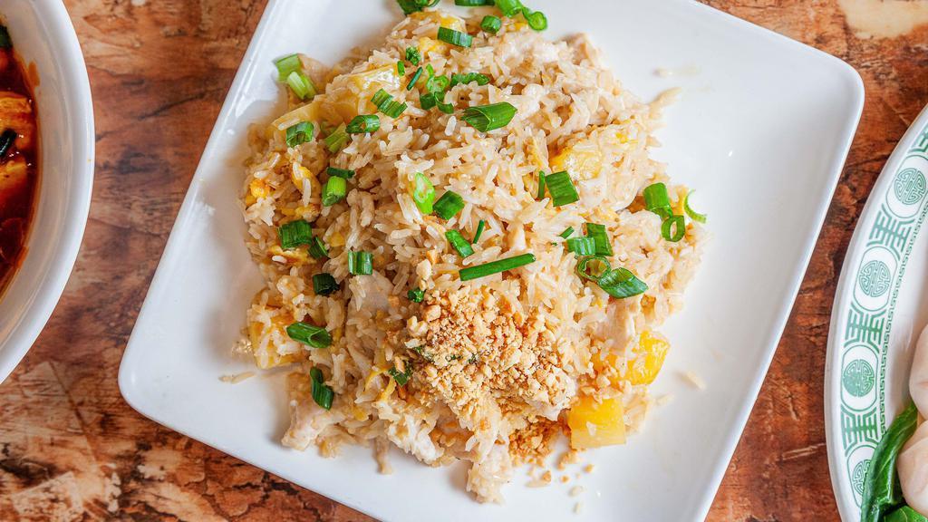 Pineapple Coconut Fried Rice · Coconut fried rice with chicken topped with ground peanuts.
