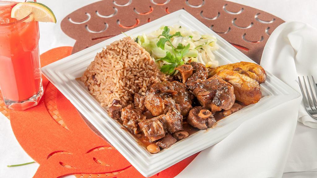Oxtail  Large Meal · Braised in a hearty brown stew loaded with carrots and butter beans. Savory and comforting served with rice and peas and vegetables.
