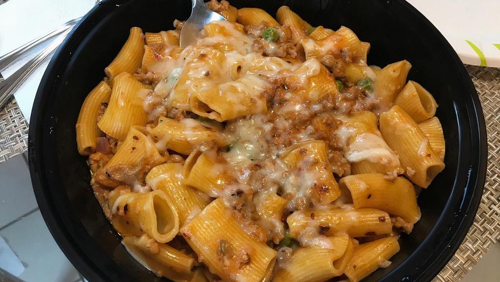 Homemade Rigatoni · crumbled sausage, onions, peas, pink cream sauce, with crusted red pepper & shaved parmigiano cheese