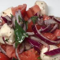 Pomodoro Salad · Tomatoes, onions and fresh mozzarella, extra virgin olive oil & basil