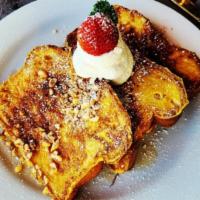 Lehua French Toast · Brown butter maple syrup, macadamia nuts, powder sugar, macadamia nuts, powder sugar.