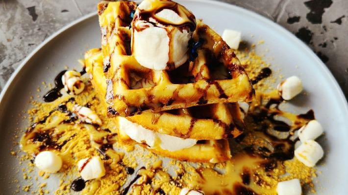 Smores Waffle · Honey graham waffle, toasted marshmallows, chocolate, condensed milk.
