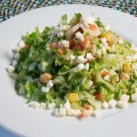 Family Chopped Salad · Chopped Salad, Romaine lettuce, tomato, hearts of palm, red onion, corn, red pepper, cucumbe...