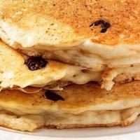 Chocolate Chips Pancakes · 3 golden pancakes stuffed with chocolate chips and topped with confectionary sugar, served w...