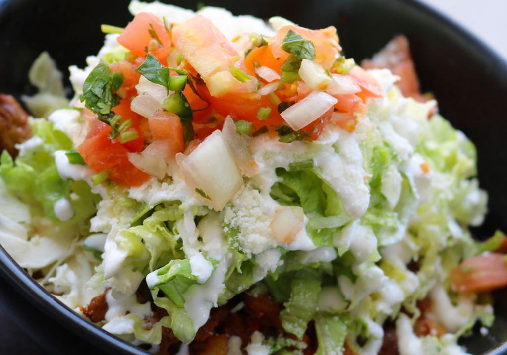 Burrito Bowl · Rice, beans, quesillo, lettuce, sour cream and pico de gallo.