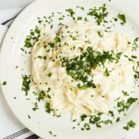 Fettuccine Alfredo · Classic cream sauce with Parmesan cheese and egg yolks.