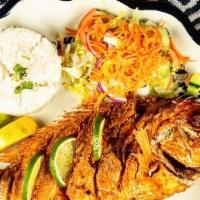 Fried Red Snapper · Whole fried red snapper served with. white rice, our house salad & limes.