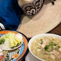 Pozole Soup · Traditional Mexican soup with pork &. corn with a side of radish, onions, two. corn tostadas...