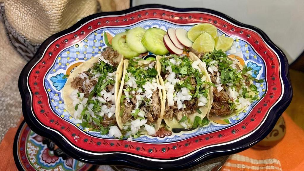 Carnitas Tacos · Traditional pork carnitas topped with. cilantro & white onion with a side of. limes, garnished with cucumber, radish. & pico de gallo.