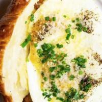 Cracked Crescent · 2 fried eggs, grated cheddar, and chives on a grilled croissant.