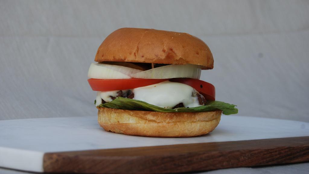 The Classic · One 6oz. beef burger with cheese, lettuce, tomatoes and onions. Lightly topped with mayo and ketchup.