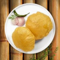 Poori  · Deep fried Indian bread cooked until golden crisp. Two pieces.