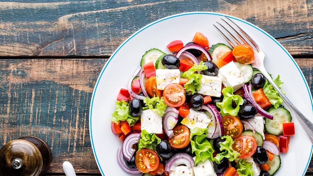 Greek Salad · Fresh Salad made with Romaine lettuce, tomatoes, bell peppers, onions, Kalamata olives, cucumbers, oregano, olive oil, white vinegar, and feta cheese.