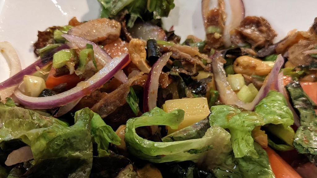 Duck Salad · Hot and spicy. Sliced roasted duck with romaine lettuce, tomatoes, pineapples and cashew nuts in spicy lime juice.