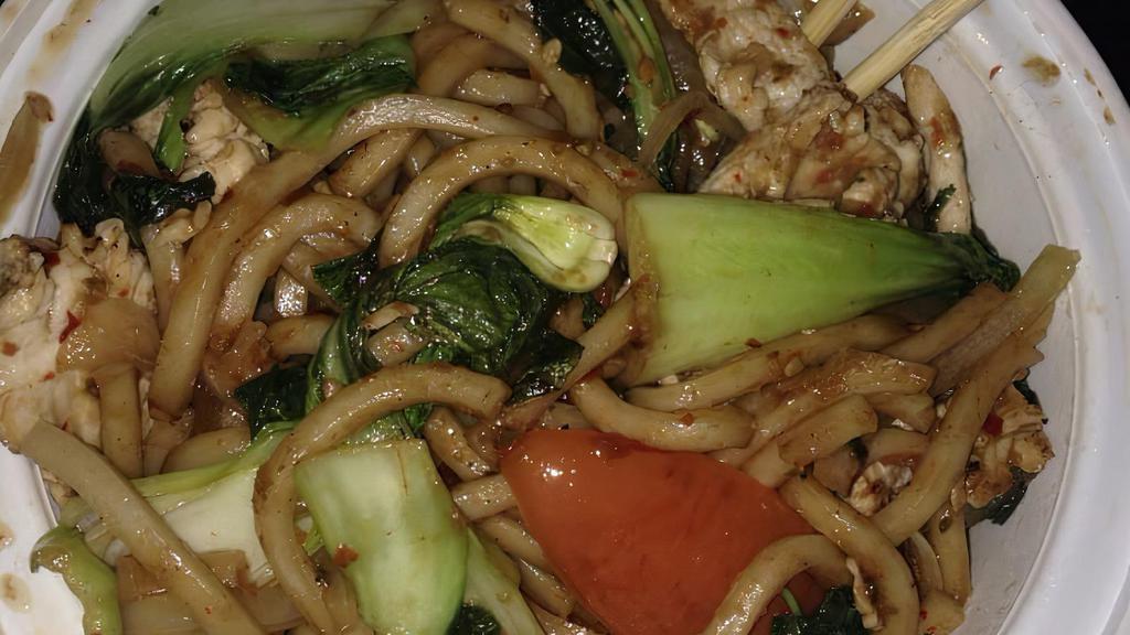 Spicy Udon Noodle · Hot and spicy. Sauteed udon noodles with your choice of protein, tomatoes, onion and bok choy in spicy chili basil sauce.