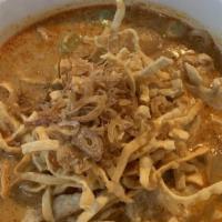 Kao Soi · Hot and spicy. Egg noodle with sliced chicken, bok choy in curry soup topped with crispy noo...