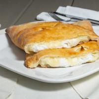 Calzone · Ricotta and mozzarella cheese, baked inside fresh dough. Served with a side of sauce.