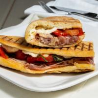 Prosciutto Panini · Roasted peppers and fresh mozzarella, tomatoes, basil and olive oil. Served on homemade focc...