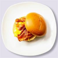 Bacon, Egg, And Cheese Sandwich · Scrambled egg, bacon, cheddar cheese, sliced tomato and caramelized