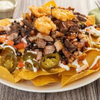 Shrimp Nachos · Homemade yellow corn tortilla chips covered with melted cheese, black beans, jalapeños, toma...