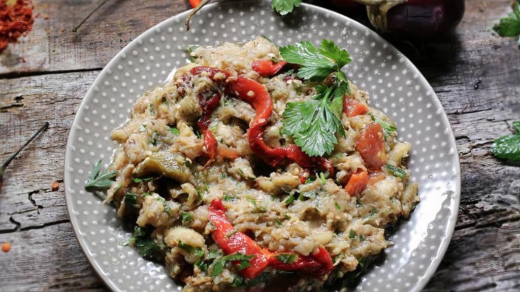 Eggplant Salad / Patlican Salatasi · Charcoal-grilled eggplant, tomatoes, green bell peppers, red bell peppers flavored with garlic herbs and parsley, lemon juice and olive oil.