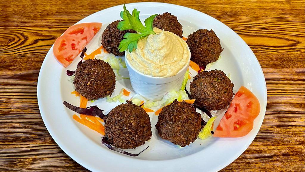 Falafel Appetizer · Chickpeas mashed with onions, parsley, garlic and deep-fried. Served with tahini sauce.