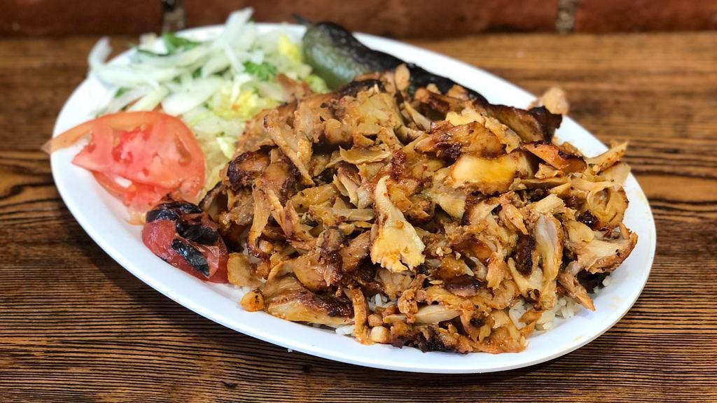 Chicken Gyro · Layers of marinated chicken thighs wrapped around the large vertical split and grilled in front of an ingenious herd of charcoal fire