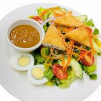Thai Salad · With peanut dressing, boiled egg, cucumber, fried tofu, onion, tomato.