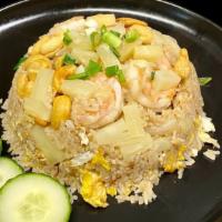 Pineapple Fried Rice · Stir-fried rice with egg, pineapple, cashew nut, onion, scallion. Choice of chicken or pork ...
