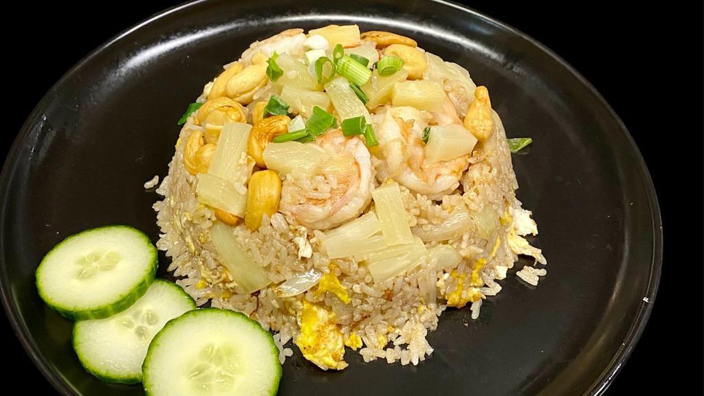 Pineapple Fried Rice · Stir-fried rice with egg, pineapple, cashew nut, onion, scallion. Choice of chicken or pork or tofu or vegetable (extra for an additional price), shrimp or beef for an extra price (extra add and egg , cashew nut, and pineapple at an additional pice).