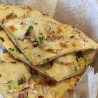 Garlic Naan · White flour bread topped with garlic and cilantro baked in tandoor.