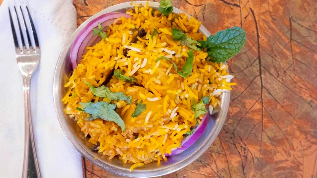 Vegetable Biryani · Rice cooked with yogurt and mélange of fresh curried vegetables, mint and coriander leaves.