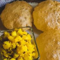 Puri Bhaji · A fluffy deep fried, whole wheat, rolled bread served with potato curry made with curry leav...