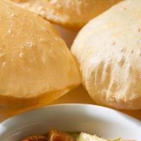 Puri Sagoo · A fluffy deep fried, whole wheat, rolled bread serviced with a special veg curry.