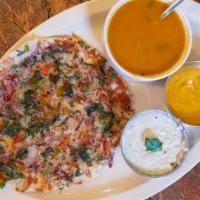 Vegetable Uttapam · With tomatoes, peas, carrots, onion and chili toppings.
