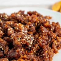 Sesame Beef · Chucks of beef fried to crispy in brown sauce. Served with roasted sesame seeds on a bed of ...