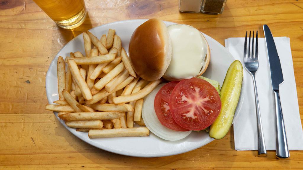 Beef Burger · Served with a pickle and side of fries.