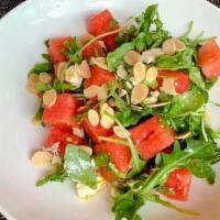 Watermelon Salad · Fresh Watermelon, Baby arugula, goat cheese, pickled red onions, toasted almonds, balsamic v...