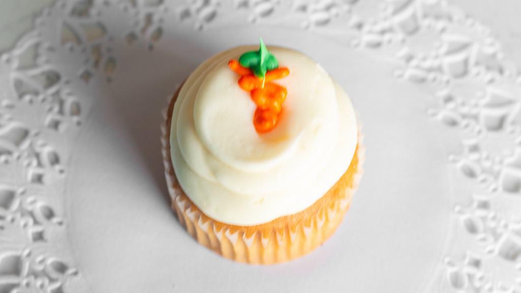 Carrot Cake · A classic carrot cake cupcake topped with a cream cheese frosting and finished with a frosting carrot.